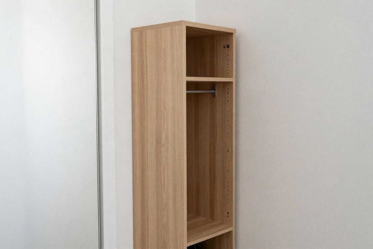 Illustrative image: Small entryway with narrow vertical shoe cabinet and decorative mirror.