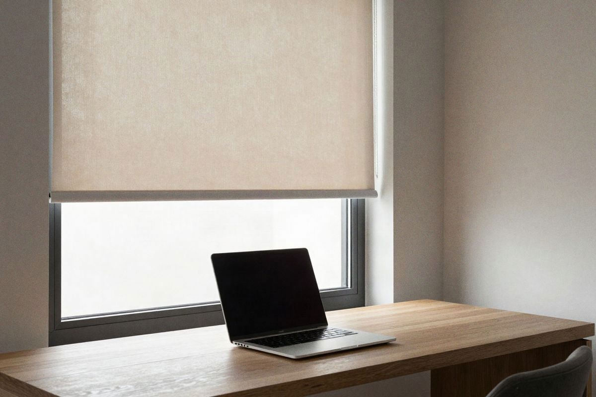 Illustrative image: home office with motorized blind controlling screen reflections