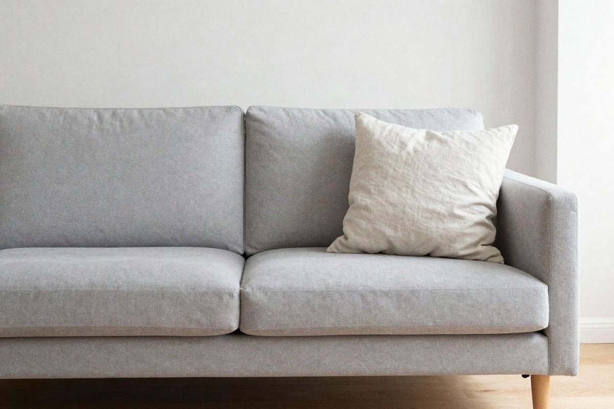 Illustrative image: two-seater sofa with a single large cushion in Nordic style