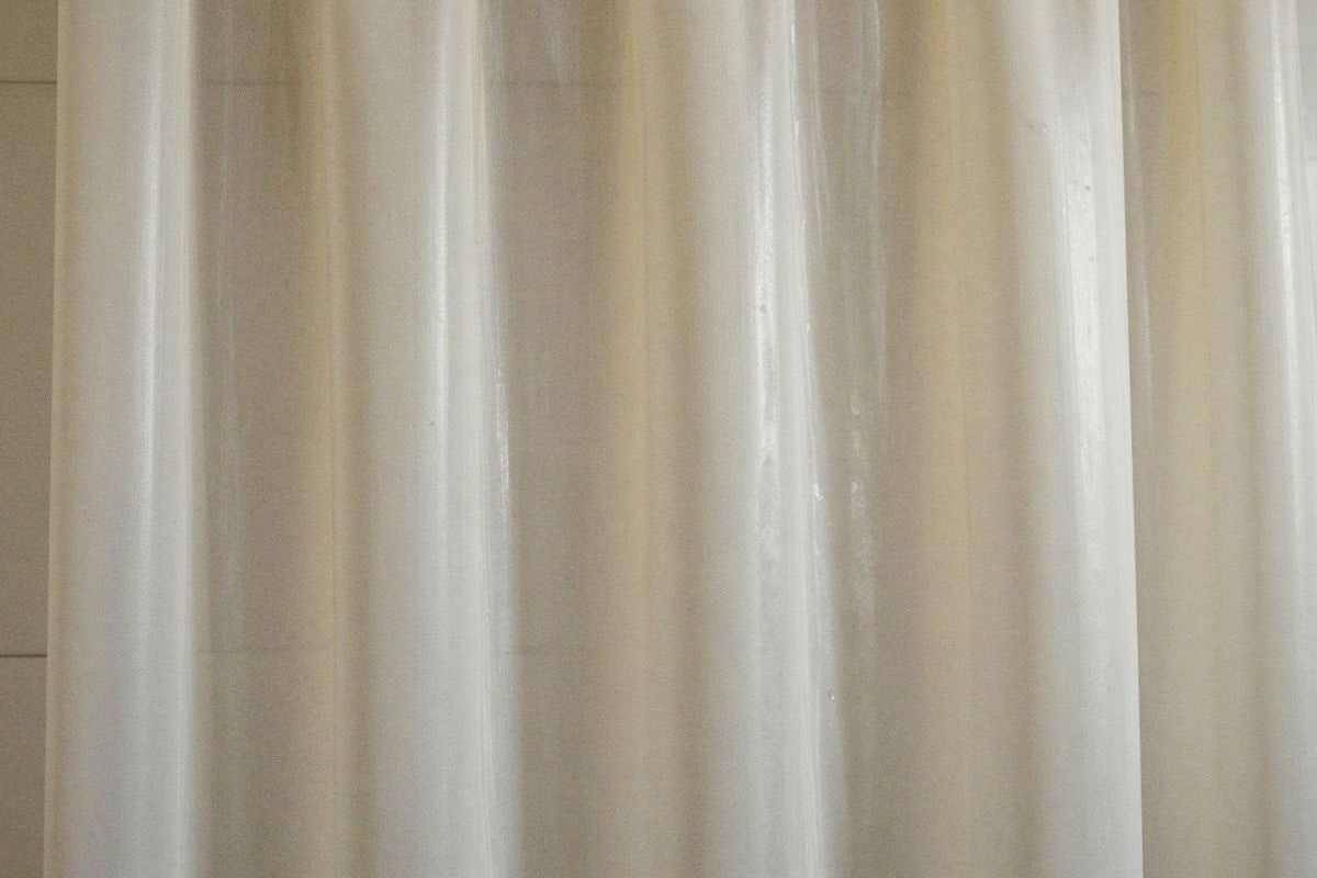 Illustrative image: deteriorated plastic curtain showing aging and brittleness
